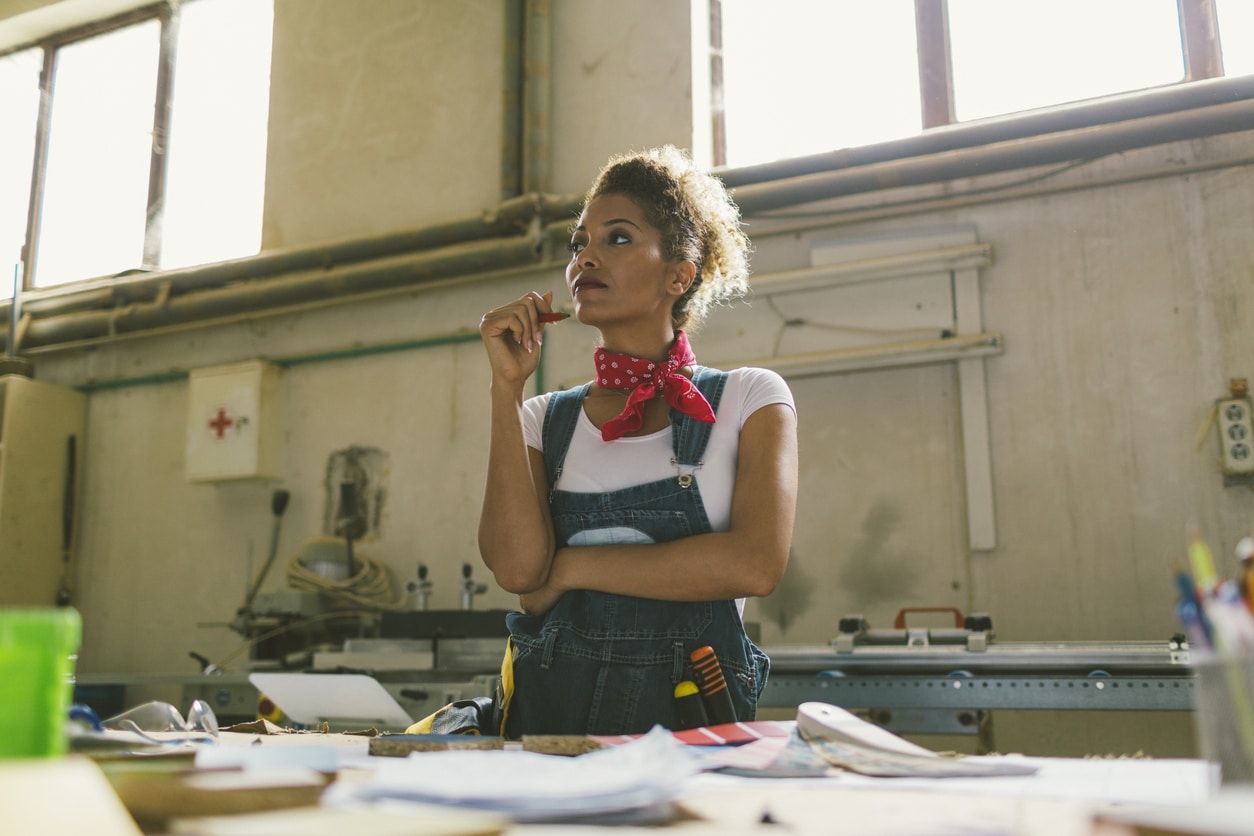 Latina Carpenter Standing In Her Workshop